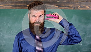 Hipster teacher formal wear with neck tie holds stapler. Back to school and studying. Teaching memorization techniques photo