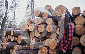 Hipster tender girl on the background of felled trees