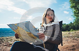 Hipster tourist planning trip with map on sun flare nature, traveler girl look landscape vacation trip, enjoy lifestyle holiday