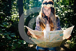 Hipster tourist woman with map hiking, lifestyle adventure concept