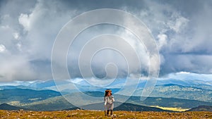 Hipster traveler on top of mountains