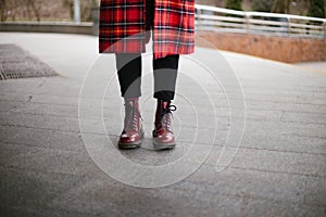 Hipster wearing red trendy boots and coat