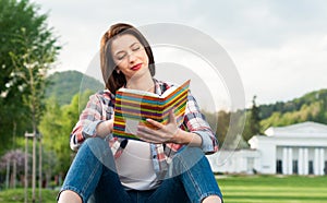 Hipster woman in casual clothes holding a book and reading