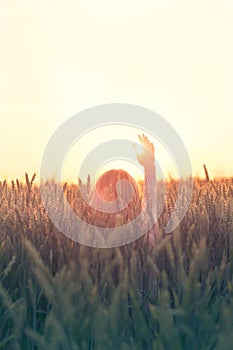 Hipster woman greets the sun in the sign of freedom