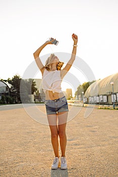 Hipster woman having fun, listening music and dancing