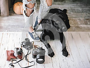 Hipster woman lags near digital cameras with a Labrador,concept,lifestyle