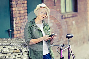 Hipster woman portrait with phone and bike