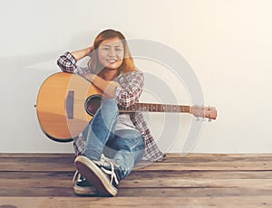 Hipster woman style portrait chillin with guitar look so happy.