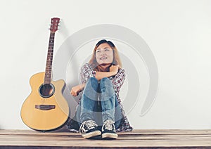 Hipster woman style portrait chillin with guitar look so happy.