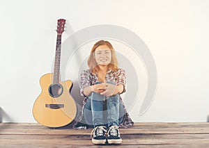 Hipster woman style portrait chillin with guitar look so happy.