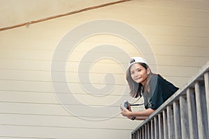 Hipster woman taking photos with retro film camera on wooden fl