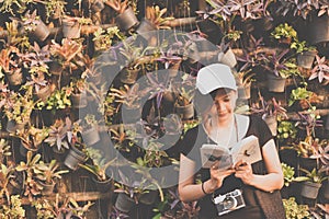 Hipster woman teenager sitting enjoy reading book at pier. Young Woman Reading Book Concept ,retro filter toned.