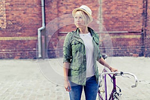 Hipster woman with vintage road bike in city