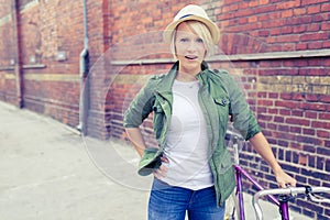 Hipster woman with vintage road bike in city