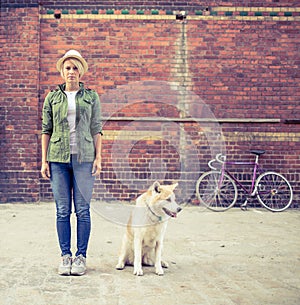 Hipster woman with vintage road bike in city