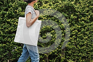 hipster woman with white cotton bag at park