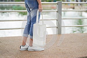 hipster woman with white tote bag in the park