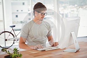 Hipster working on computer at desk