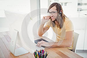 Hipster working at computer desk