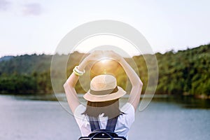 Hipster young asian woman showing hands heart shape at sunset,Happy and smiling,Positive thinking