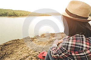 Hipster young girl with bright backpack enjoying sunset on peak mountain. Travel Lifestyle adventure concept