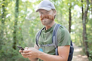 hipster young man with backpack using smart phone