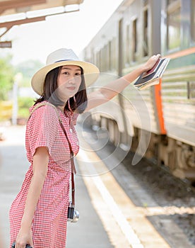 Hipster young traveler waiting train at station