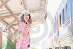 Hipster young traveler waiting train at station