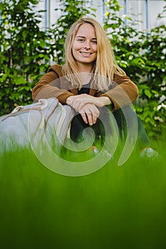 Hipster young woman in park with a backpack