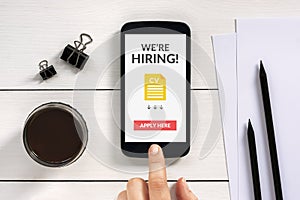 We are hiring apply now concept on smartphone screen with office