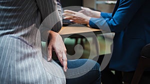 Hiring, interview. Woman hides under the table fingers cross, excitement and stress.