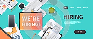 We are hiring recruitment concept top angle view desktop laptop smartphone paper document financial report office stuff