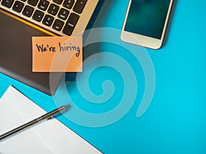 We are hiring to be message in the letter  on the blue background