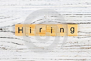 HIRING word made with wooden blocks concept