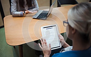 Hiring, you`re hired. The woman holds a tablet in her hand