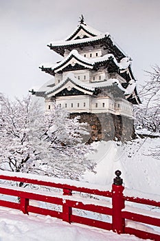 Hirosaki Castle and its red wooden bridge in winter season, Aomori, Tohoku, Japan