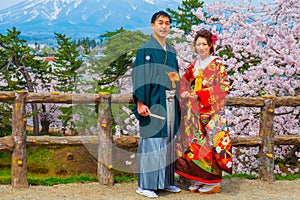 Japanese couple attend a Japanese traditional wedding ceremony at Hirosaki Park