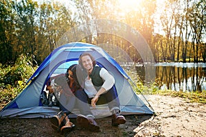 His first but definitely not his last camping trip. an adventurous couple out camping with their dog.