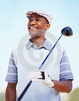 His golf game has come a long way. a confident african american golf player holding a driver.