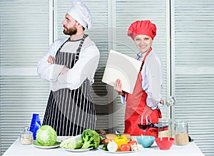 In his hands off manner. Master chef keeping arm crossed in kitchen. Pretty book keeper holding account report and cash