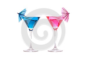 His and hers party cocktails. Blue and pink fun drinks in cocktail glasses.