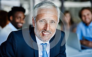 His managerial expertise keeps their meetings productive. Portrait of a mature businessman having a meeting with his