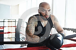 His mind is his secret weapon. a young man training in a boxing ring.