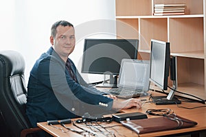In his own cabinet. Polygraph examiner works in the office with his lie detector`s equipment