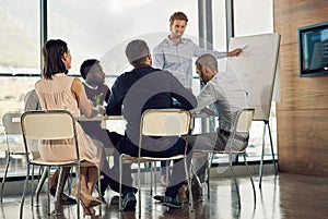 His proposal has there attention. Full length shot of a young businessman giving a presentation.