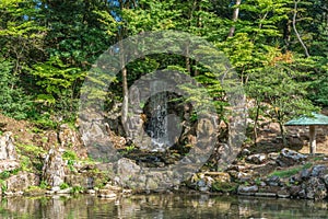 Hisagoike pond and Emerald Waterfall (Midori-taki) at Kenrokuen Garden. Kanazawa City, Japan