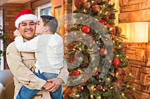 Hispanic Armed Forces Soldier Wearing Santa Hat Hugging Son