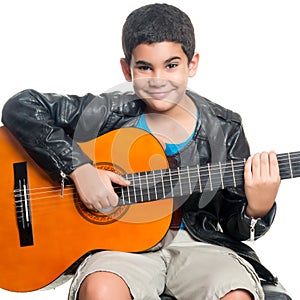 Hispanic boy playing an acoustic guitar