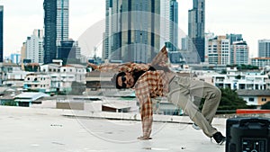 Hispanic break dancer practice B boy dance with friends at roof top. Endeavor.