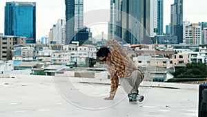 Hispanic break dancer practice B boy dance with friends at roof top. Endeavor.